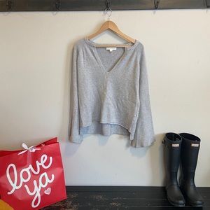 Gray sweater with flared sleeves